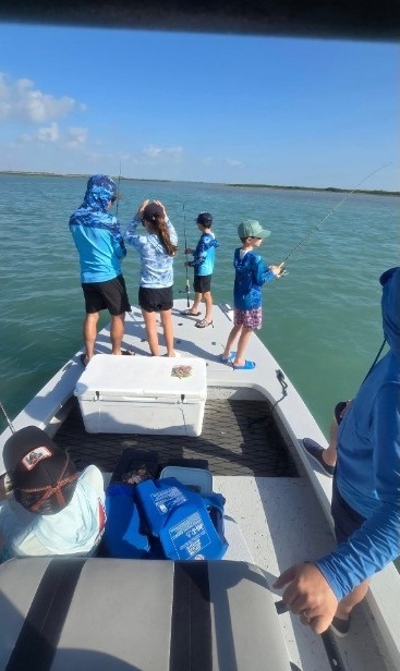 Kids fishing from the Majek on a sunny bay day