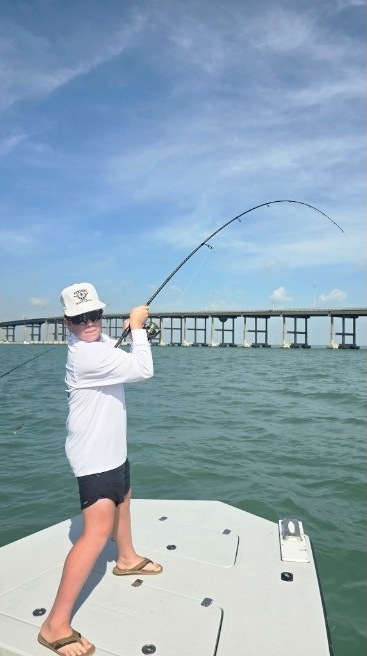Angler hooked up near a bridge on the Laguna Madre