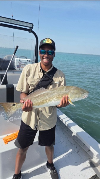 Angler holds a fish on the bow.