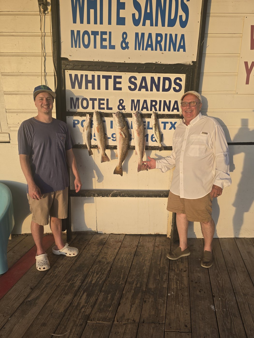 Anglers with redfish and trout on the board at White Sands