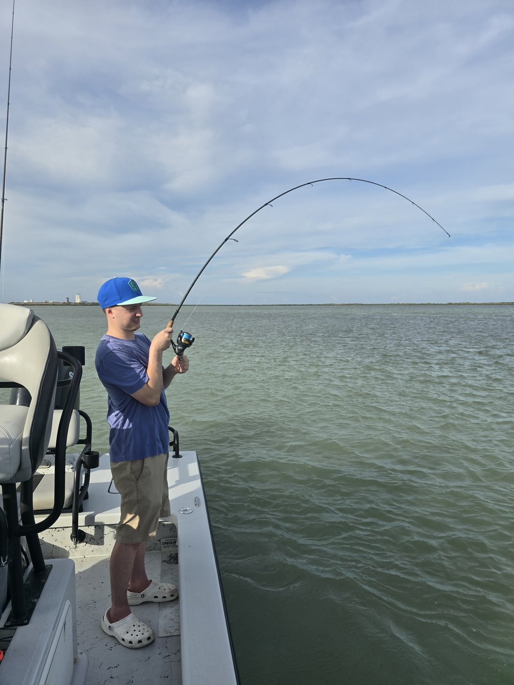 Angler fighting a fish with a bent rod